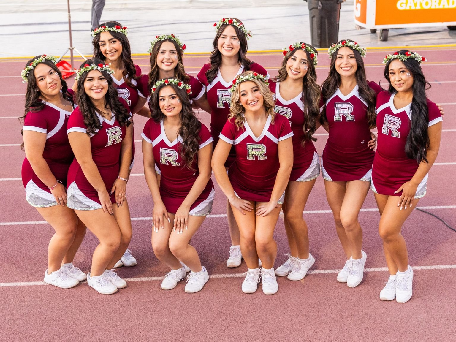 a group of cheerleaders posing for a photo