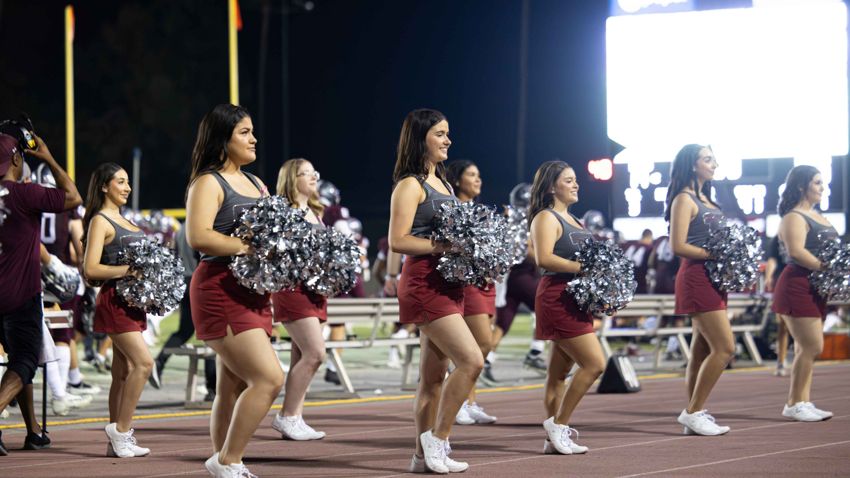 a group of cheerleaders on a track