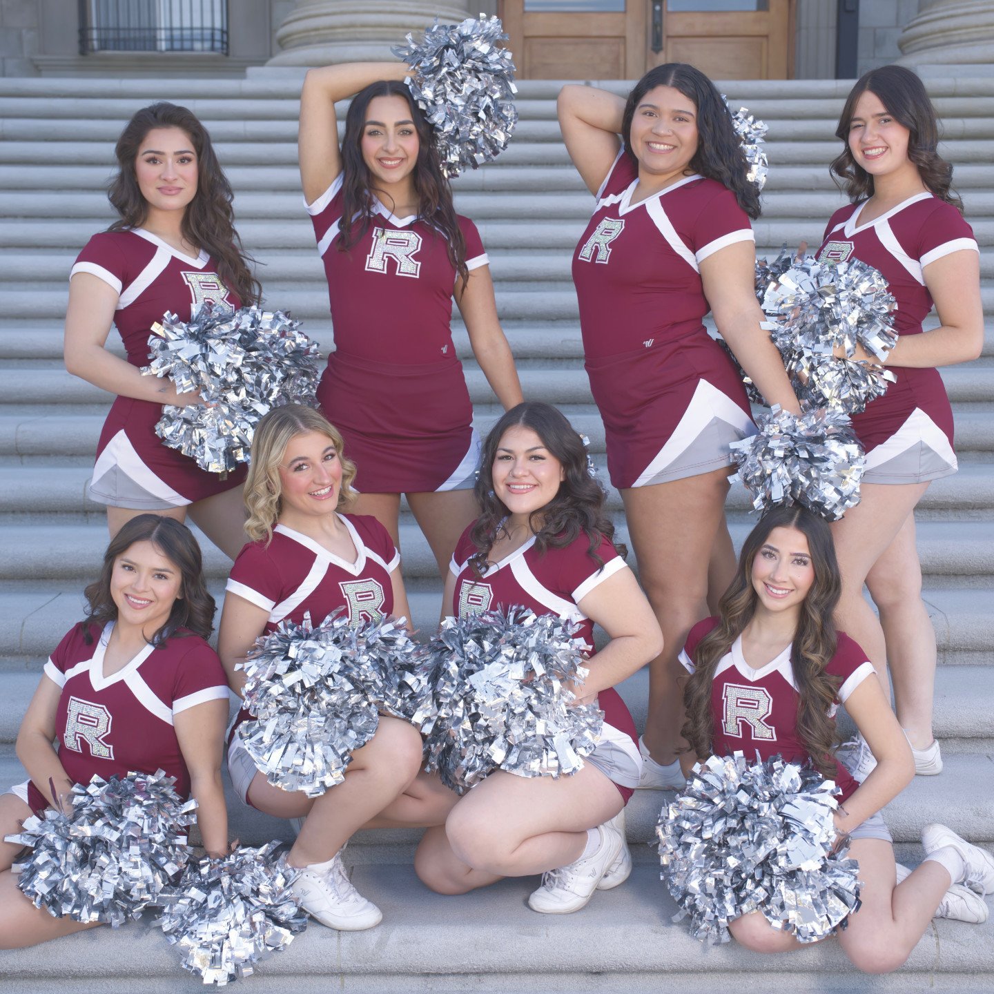a group of cheerleaders posing for a photo