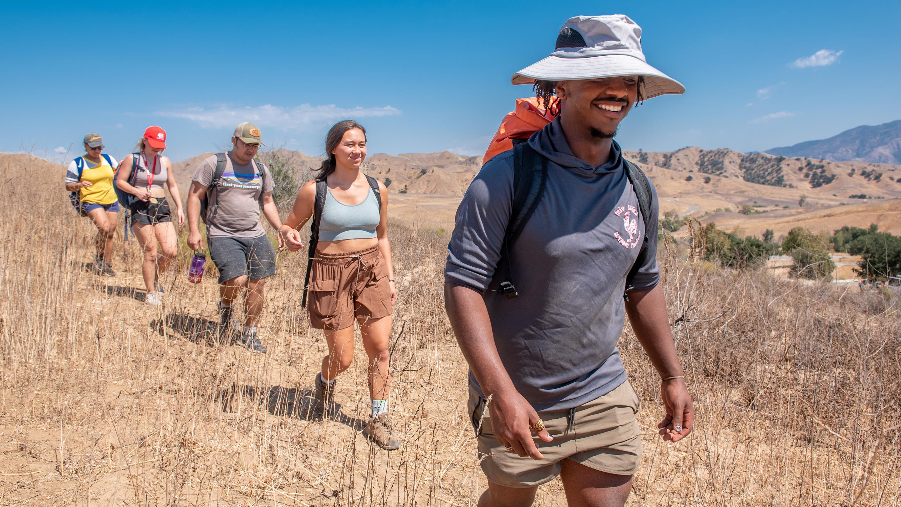 a group of people hiking in a field