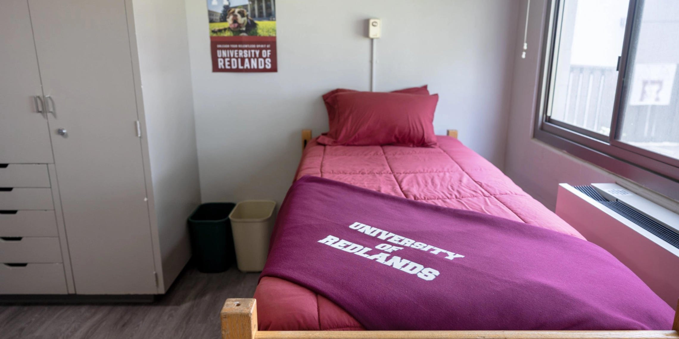 a bed with a blanket and pillows in a room