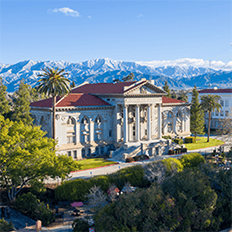a building with trees and mountains in the background