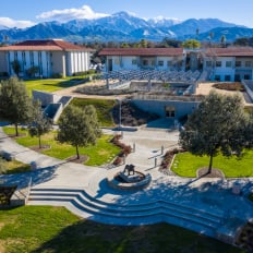 a building with trees and a fountain in front of it
