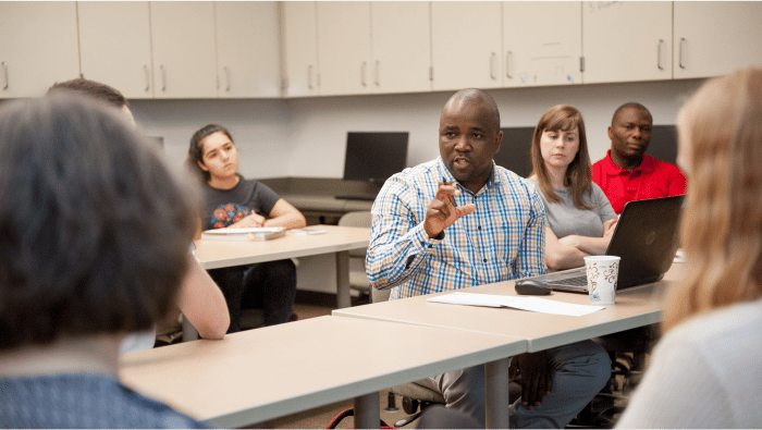 a man talking to a group of people