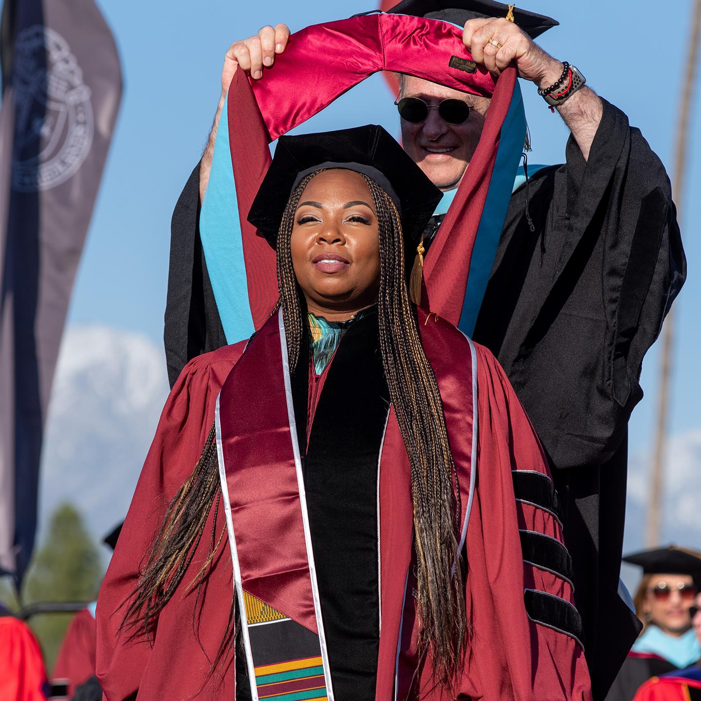 Mutiple media - Graduate student being hooded in graduation ceremony
