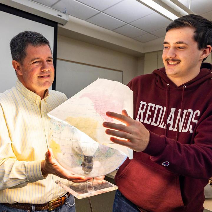 Media card - GIS professor teaching student in class