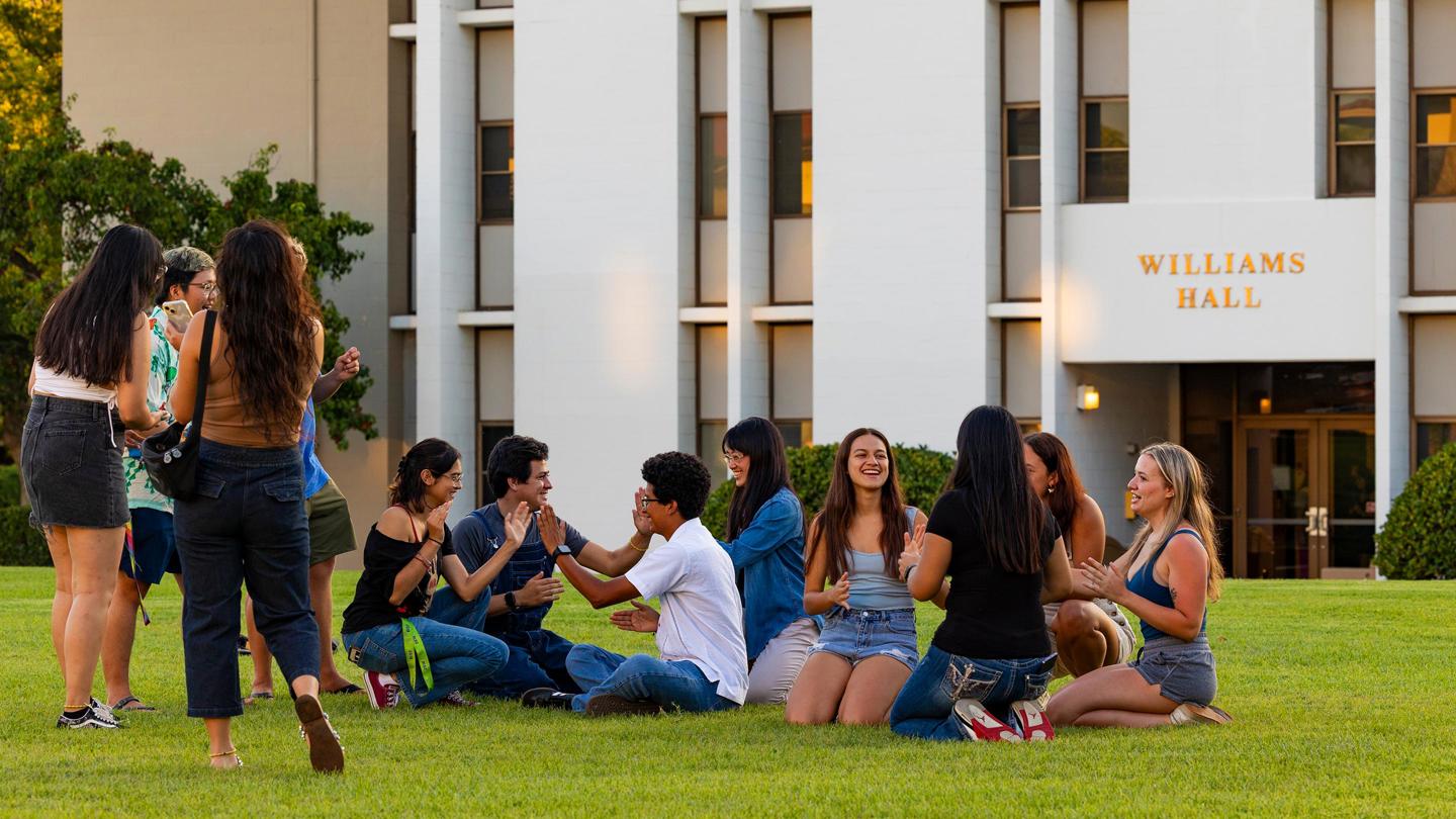 Media masthead - First-year students on grass