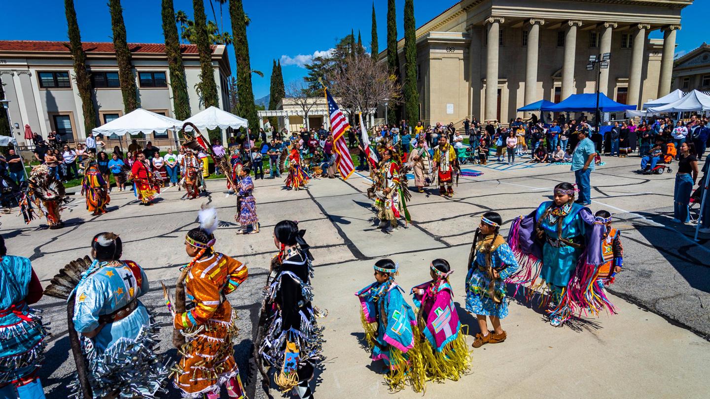 California natives performing cultural dances in front of the Memorial Chapel.