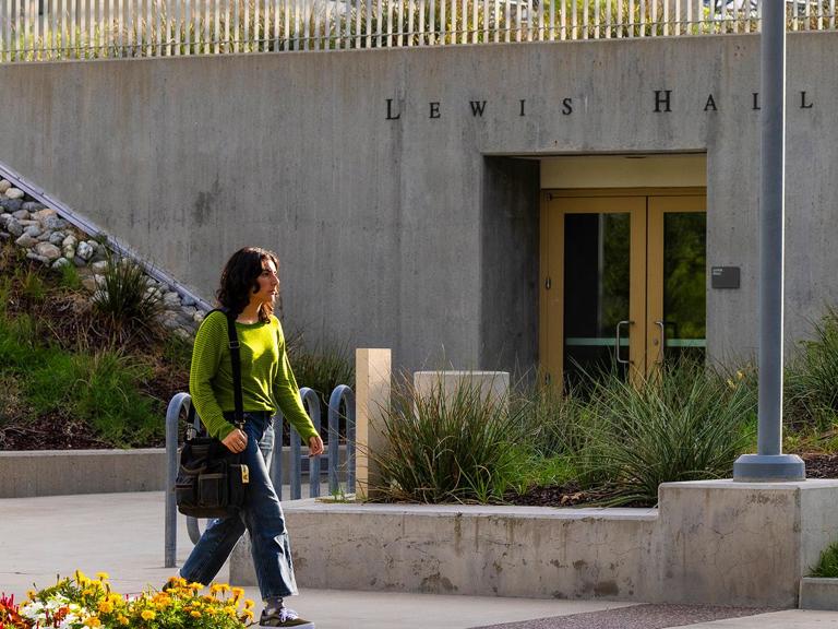 Program media masthead - GIS student walking past Lewis Hall