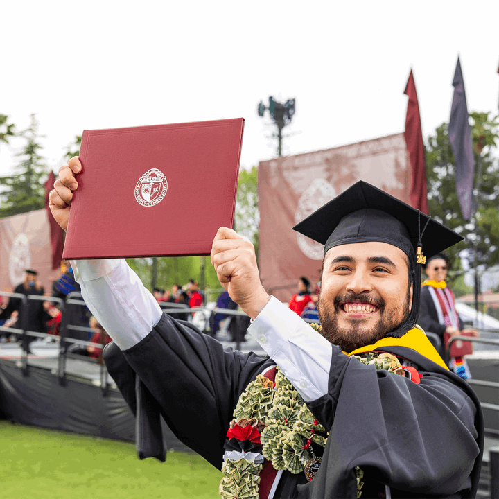 Mutiple media card - Graduate proudly holding up diploma