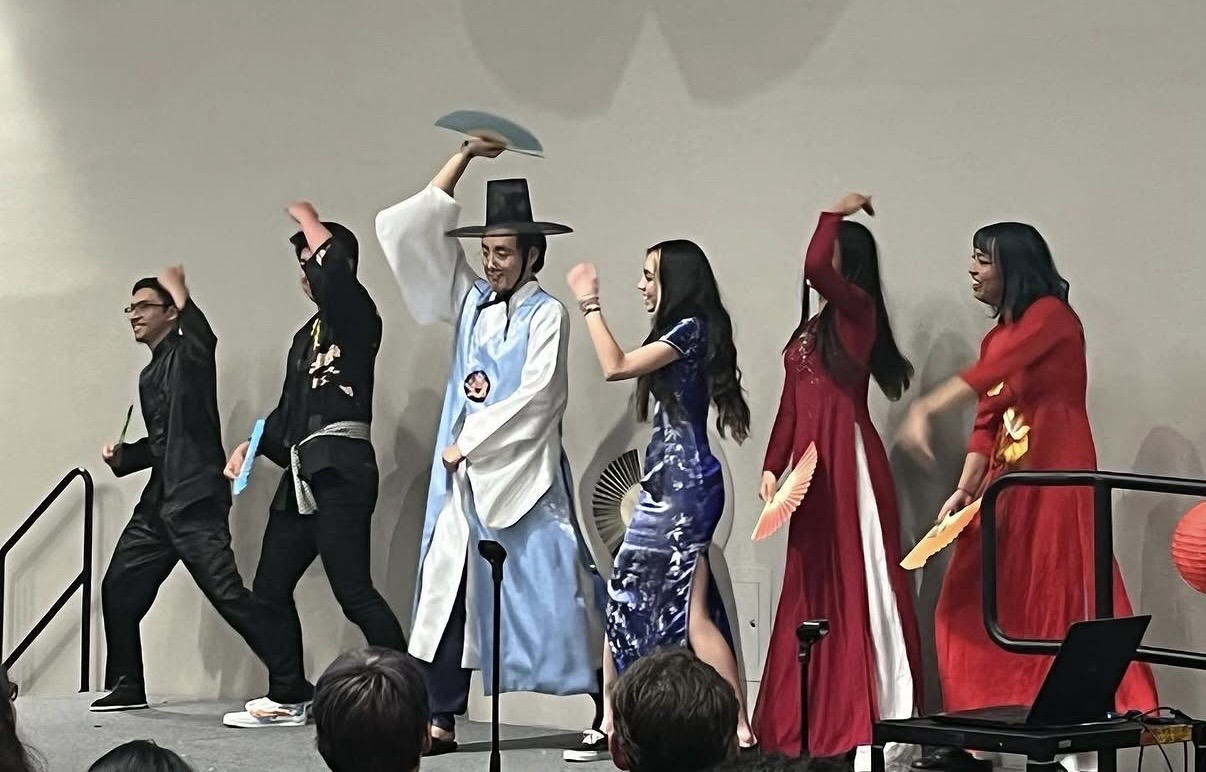 a group of people dancing on a stage