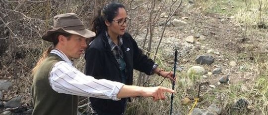 An expert and a student in the forest.