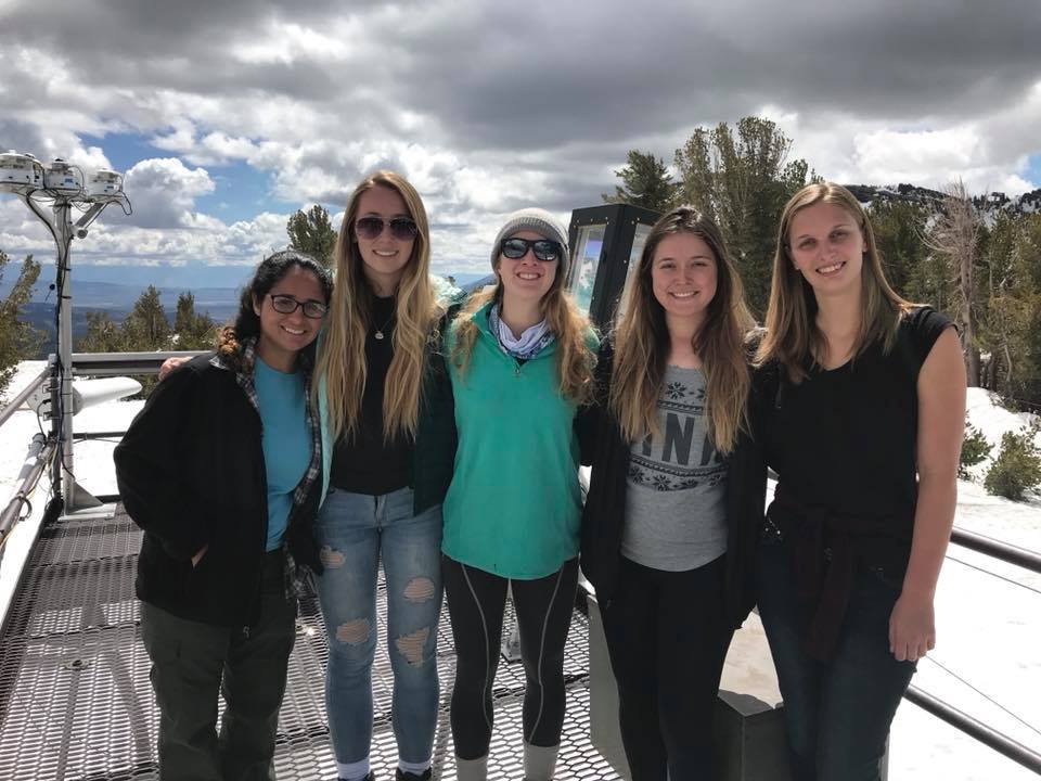 Students posing in front of the snow science station.
