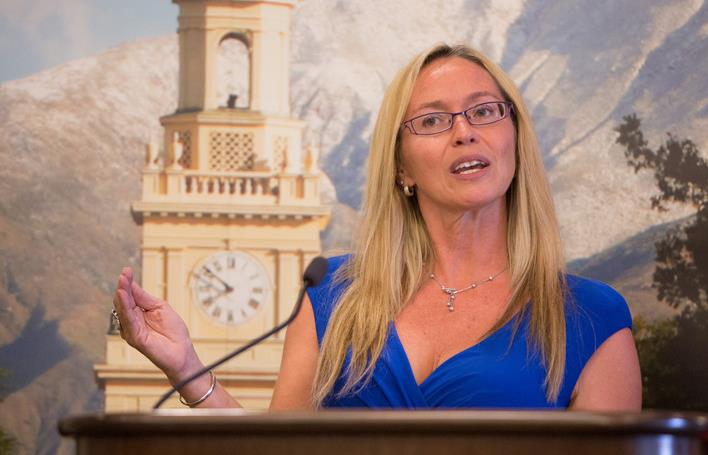 a woman standing at a podium