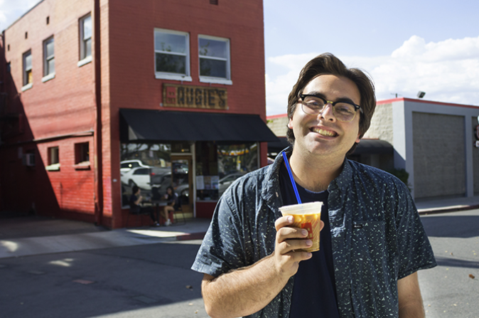 a man holding a drink