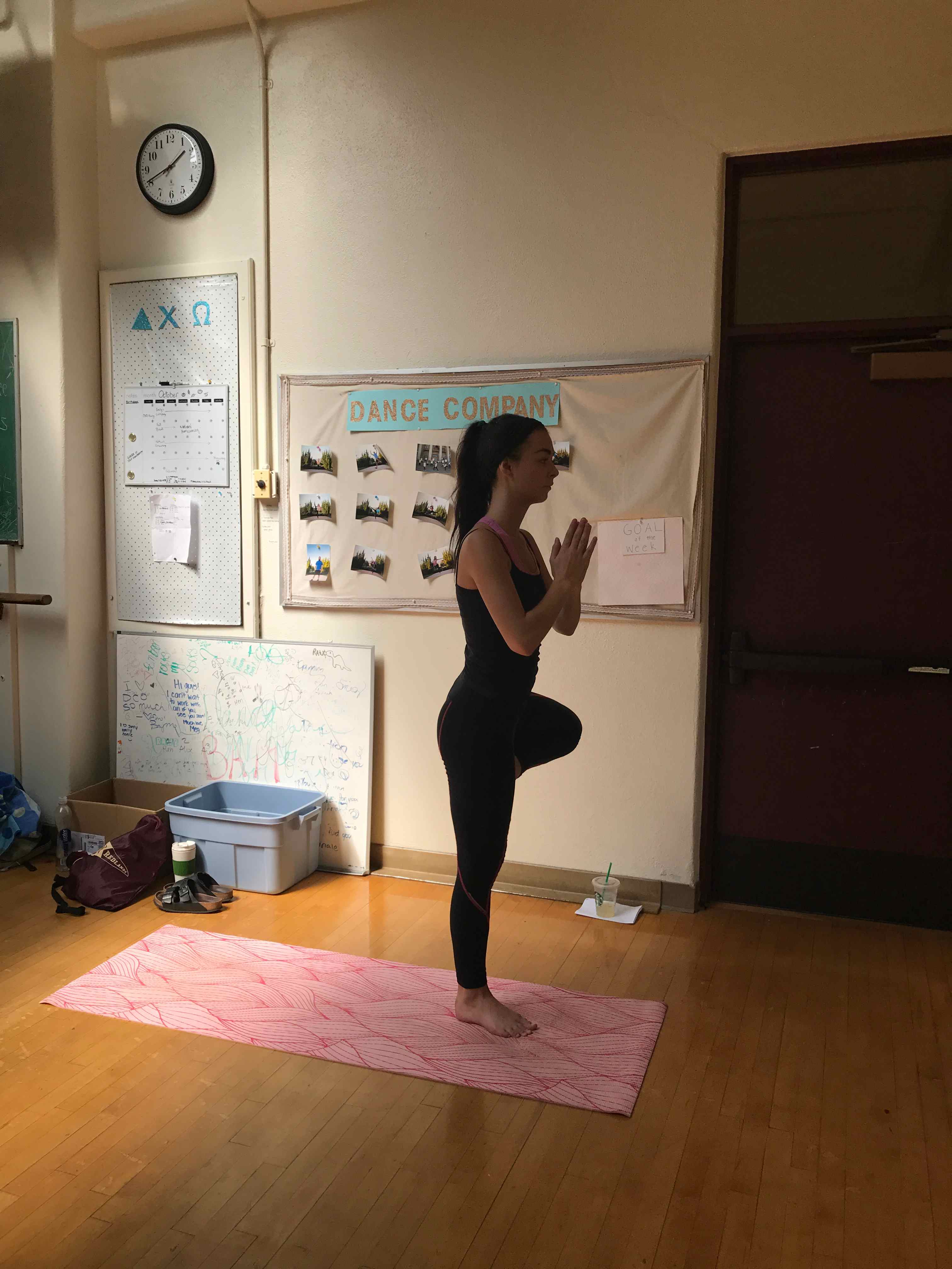 a woman standing on one leg in a yoga pose