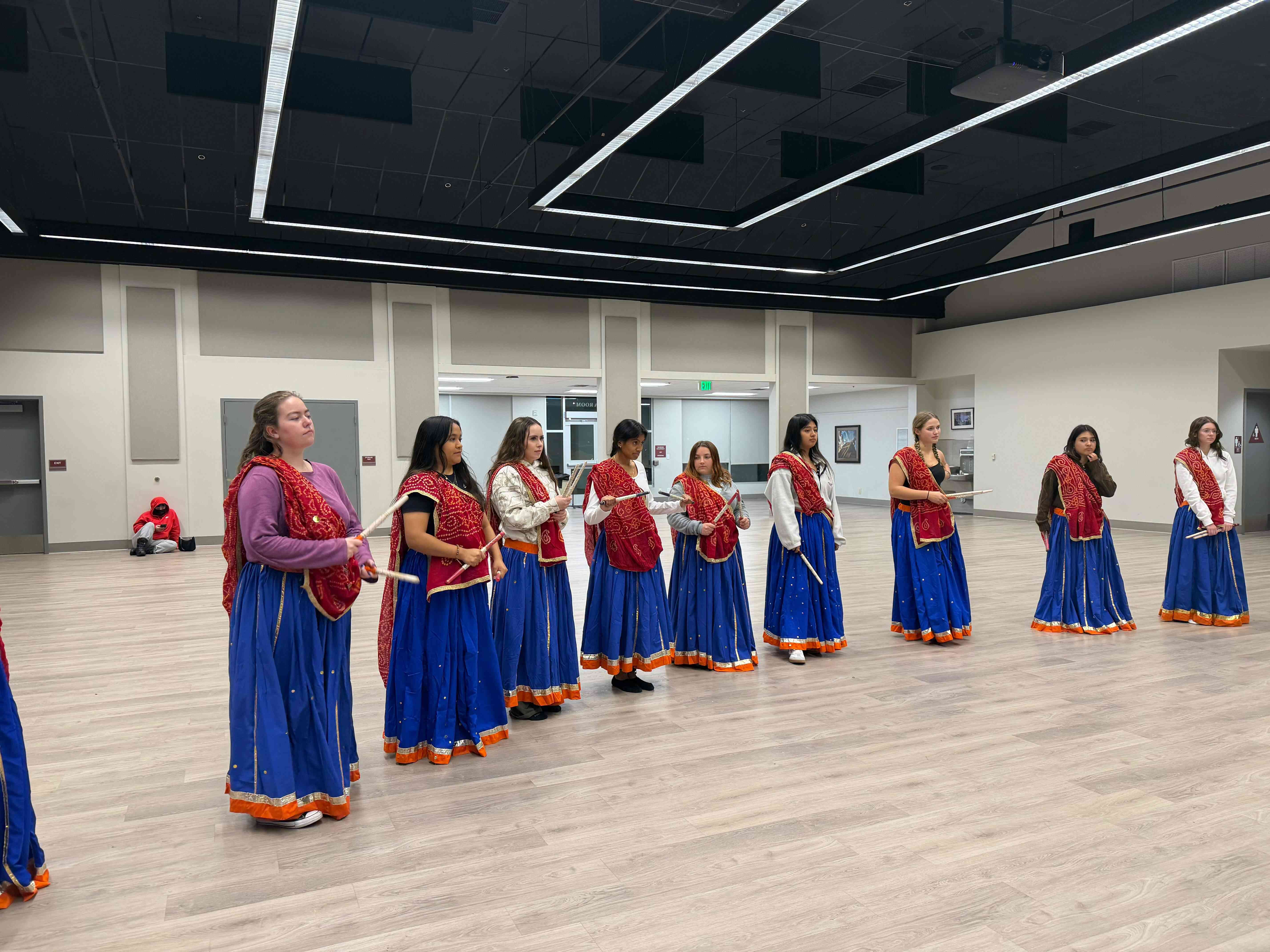 a group of women in blue and red dresses